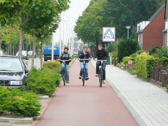 Drei Jungen nebeneinander Fahrräder fahren, am ein Radweg in den Niederlande